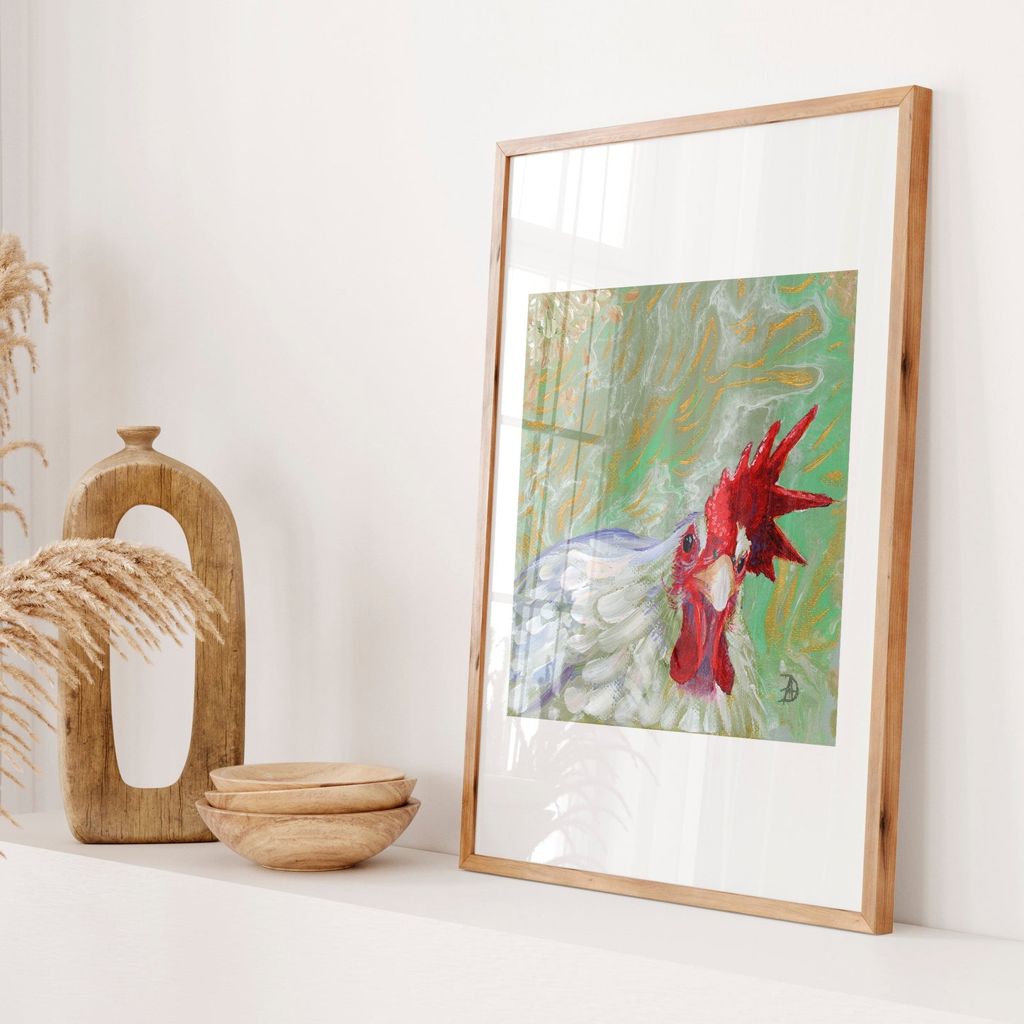 Framed display of a painting of a white rooster looking straight at the viewer